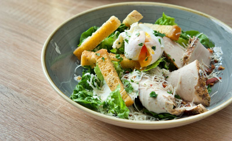 Caesar Salad side with croutons and parmesan shavings