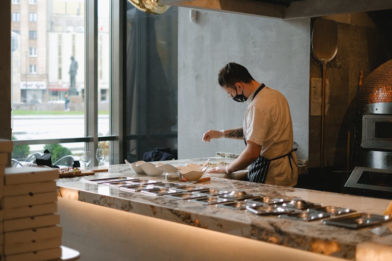 Apache Pizza stone-baked pizza preparation in Dublin kitchen